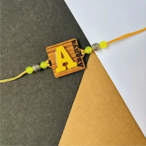 1-1-no-gift-wood-initial-name-rakhiyellow-1.webp Wood Initial Name Rakhi Yellow - Personalised Rakhi for Brother by Bubbly Decors
