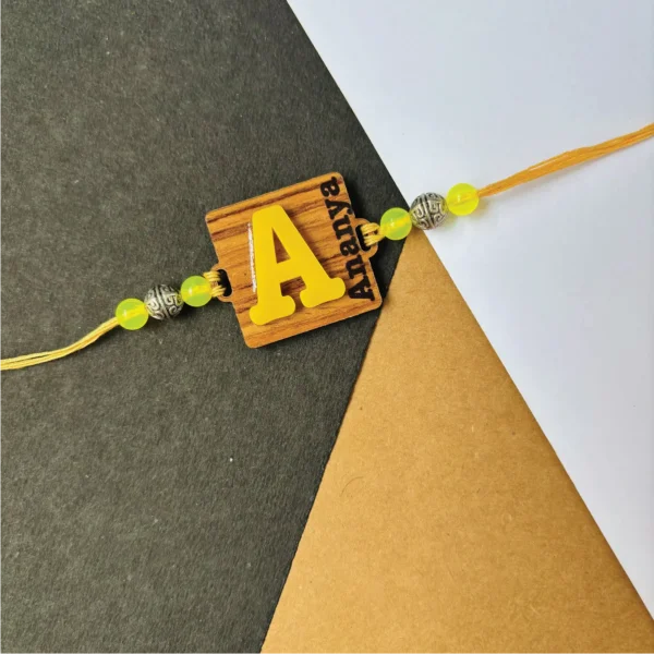 1-1-no-gift-wood-initial-name-rakhiyellow-1.webp Wood Initial Name Rakhi Yellow - Personalised Rakhi for Brother by Bubbly Decors
