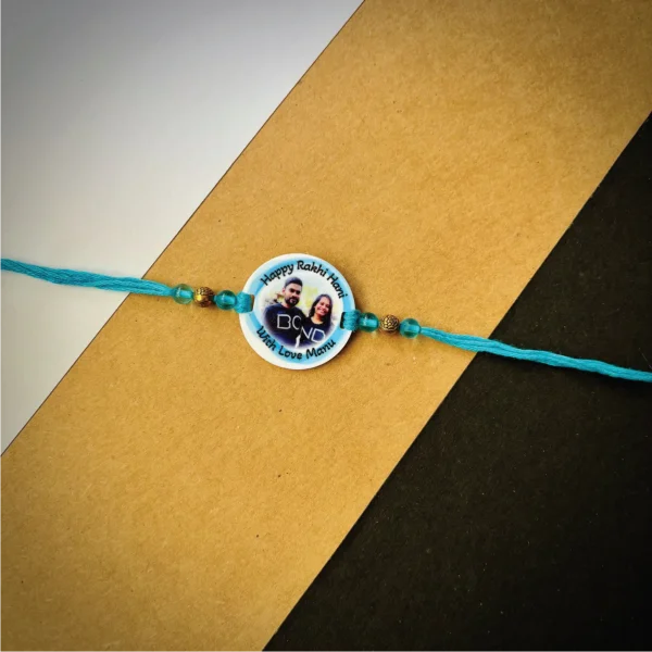 103-1-no-gift-color-photo-names-rakhiblue-1.webp Color Photo Names Rakhi Blue - Personalised Rakhi for Brother by Bubbly Decors