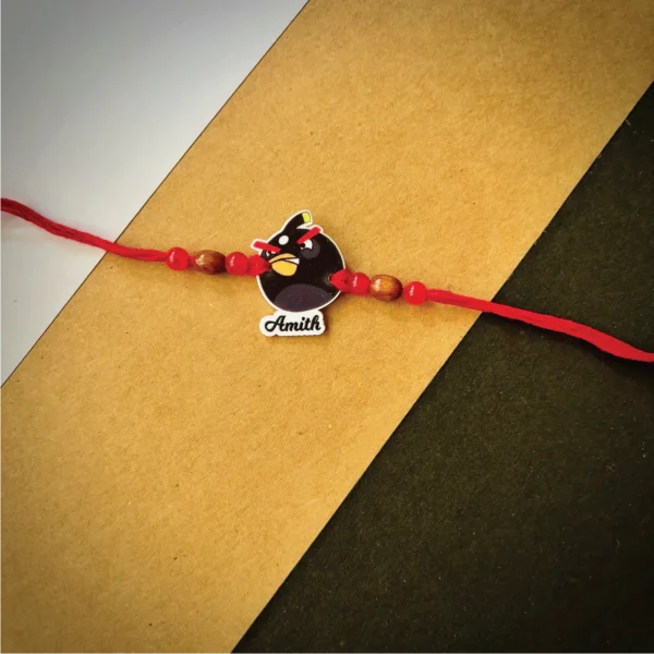 121-1-no-gift-bomb-bird-namerakhi-1.webp Bomb Bird Name Rakhi - Personalised Rakhi for Brother by Bubbly Decors