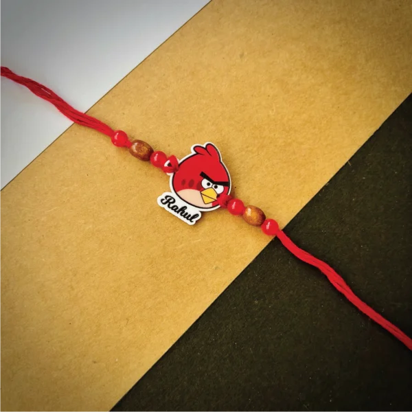 140-1-no-gift-angry-bird.rakhi_.webp Angry Bird Rakhi - Personalised Rakhi for Brother by Bubbly Decors