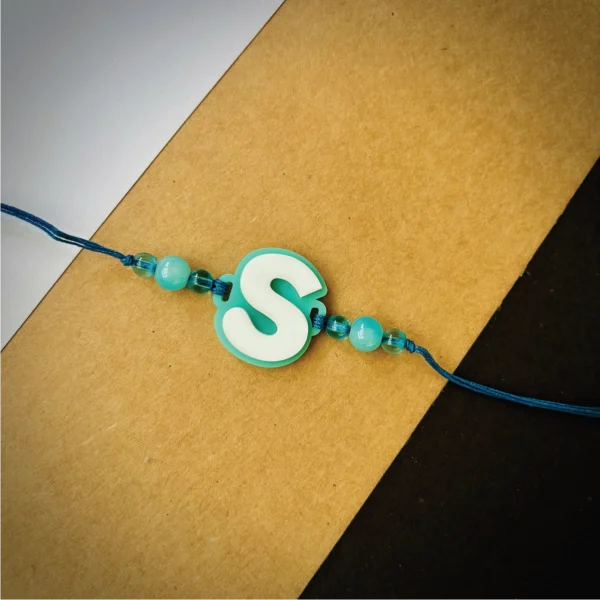 144-1-no-gift-alphabet-rakhicyan-1.webp Alphabet Rakhi Cyan - Personalised Rakhi for Brother by Bubbly Decors