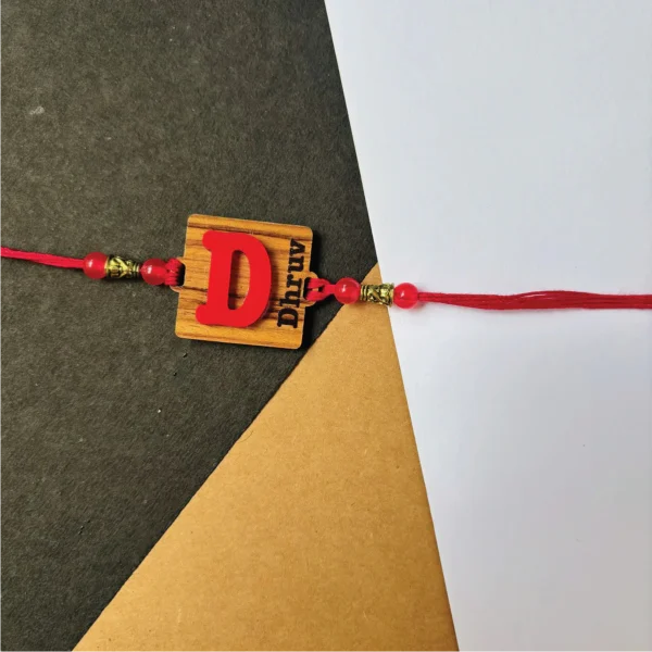2-1-no-gift-wood-initial-name-rakhired-1.webp Wood Initial Name Rakhi Red - Personalised Rakhi for Brother by Bubbly Decors