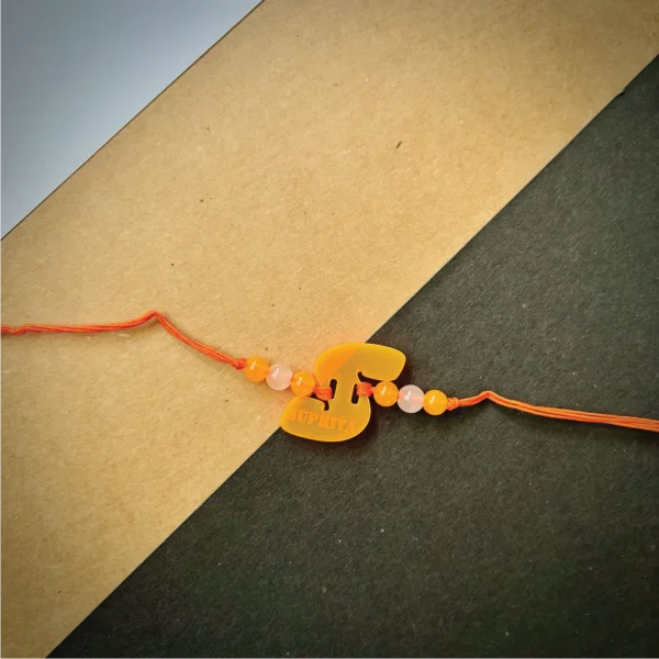 24-1-no-gift-radium-name-alphabet-rakhiorange-1.webp Radium Name Alphabet Rakhi Orange - Personalised Rakhi for Brother by Bubbly Decors
