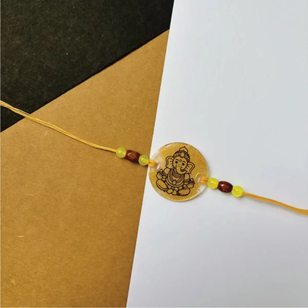 67-1-no-gift-gold-painted-vinayakarakhi-1.webp Gold Painted Vinayaka Rakhi - Personalised Rakhi for Brother by Bubbly Decors