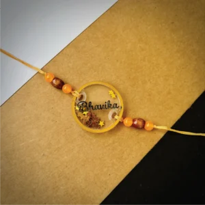 70-1-no-gift-glitters-filled-name-rakhiorange-1.webp Glitters Filled Name Rakhi Orange - Personalised Rakhi for Brother by Bubbly Decors