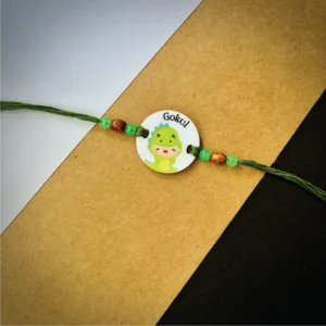 93-1-no-gift-cute-monstar-baby-dinaser-namerakhi-1.webp Cute Monstar Baby Dinaser Name Rakhi - Personalised Rakhi for Brother by Bubbly Decors